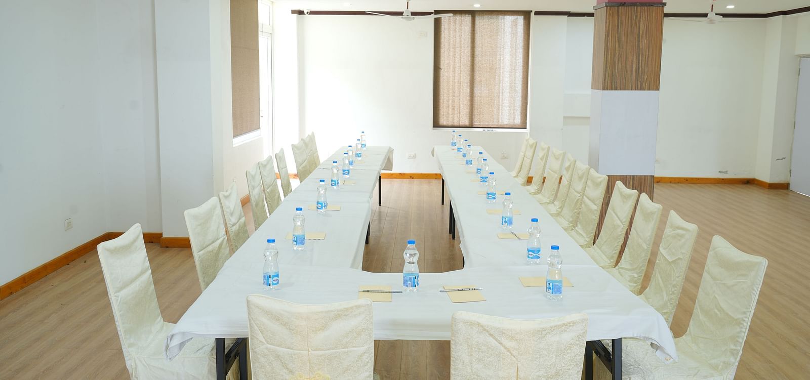 Image of the conference room featuring a large table and several chairs around it | DLS Hotel Shiva Sanctuary and Spa